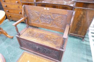 20th century Victorian inspired monks bench with carved top and seat with lift up section,