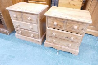 Two low pine 2/2 bedside chests of drawers