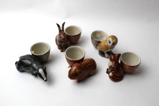 Five quail pottery egg cups, guinea pig, badger, hare,