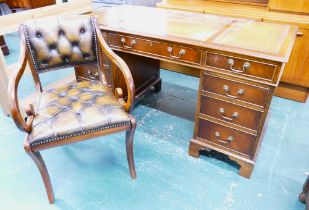 Brown leather tooled top pedestal desk and matching chair.