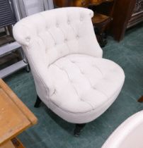 Deep buttoned low cream upholstered chair