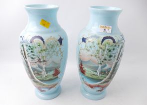Pair of overpainted pale blue glass vases,