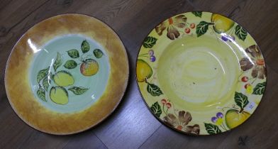 Two large ceramic table centre bowls decorated with flowers and fruits,
