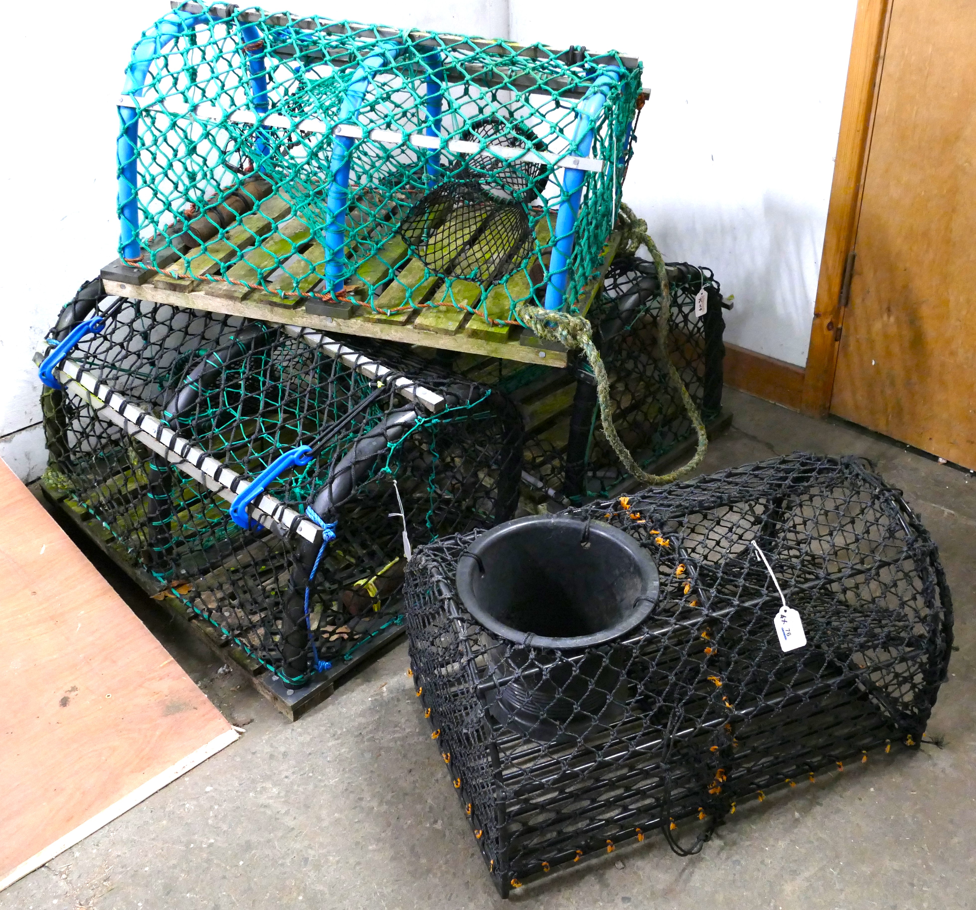 Four lobster pots (possibly used as pub/