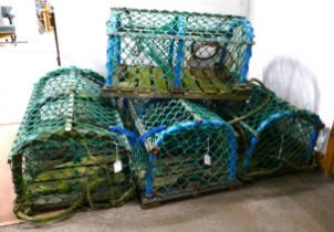 Four lobster pots (possibly used as pub/