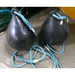 Two black fishing trawler buoys with rop