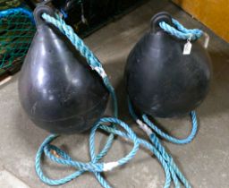 Two black fishing trawler buoys with rop