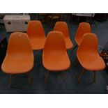 Six orange retro style chairs