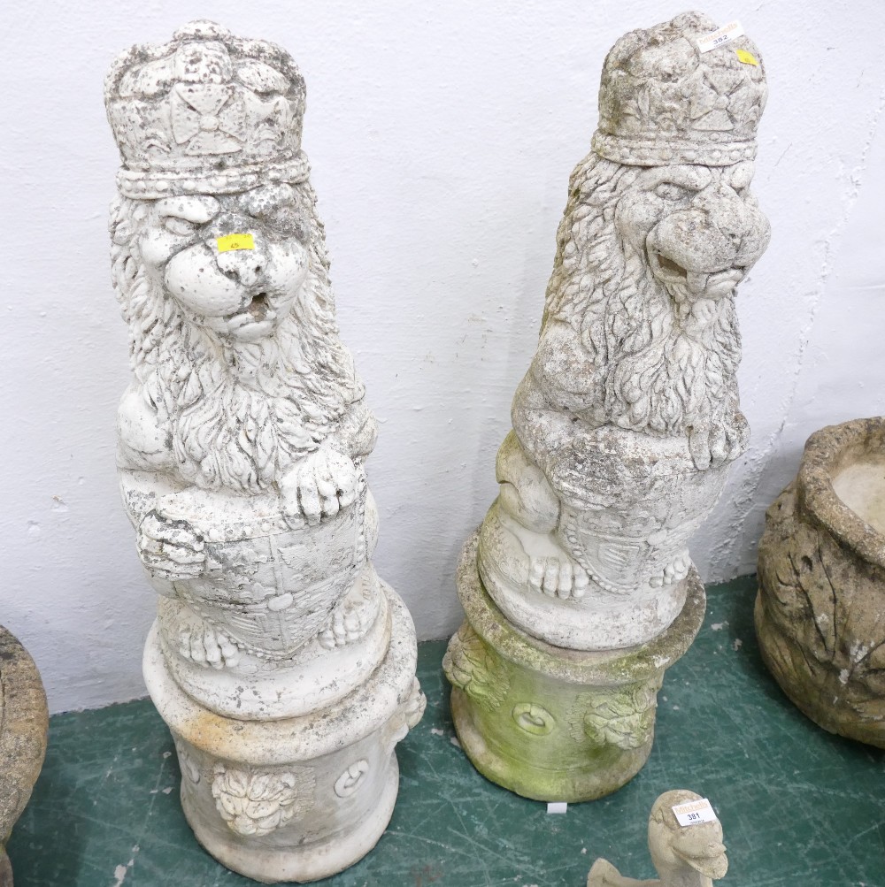 Pair of classical style garden lions ornaments on stands