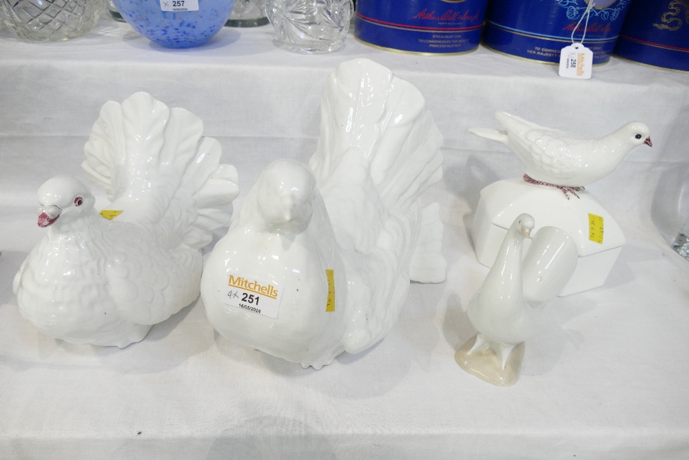 Four ceramic dove ornaments