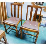 Two chairs with brown leather drop in seats