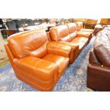 Two orange leather armchairs and two seater settee