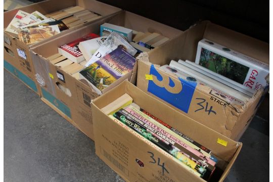 Four boxes of books including paperback novels, cookbooks,