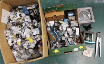 Two boxes of watch repairing equipment, strap parts,