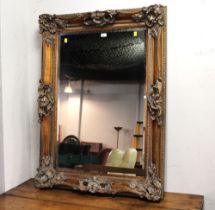 Large ornate gold coloured wall mirror,
