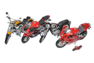 Four 1/6 New Ray (or similar) plastic and diecast motorcycles as shown. BMW, Ducatti, Honda and