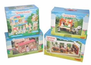Sylvanian Families comprising four boxed playsets to include Bakery, Primrose Nursery, Caravan and