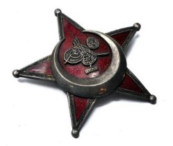 A WW1 original War Medal comprising the Turkish Gallipoli Star. In silver and red enamel, BB&CO to