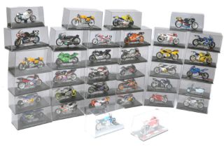 A group of 36 diecast 1/24 model motorcycles in display cases as shown. All look to be secure and
