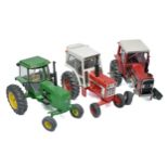 A group of assembled plastic Ertl Farm Model Tractor Kits, Massey in need of some attention.