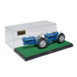 A well adapted Britains Farm 1/32 Model of a Doe 130 Tractor with custom wheels and parts as