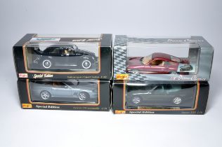 A group of 4 boxed 1:18 scale diecast vehicles from Maisto. Displayed.