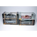 A group of 4 boxed 1:18 scale diecast vehicles from Maisto. Displayed.