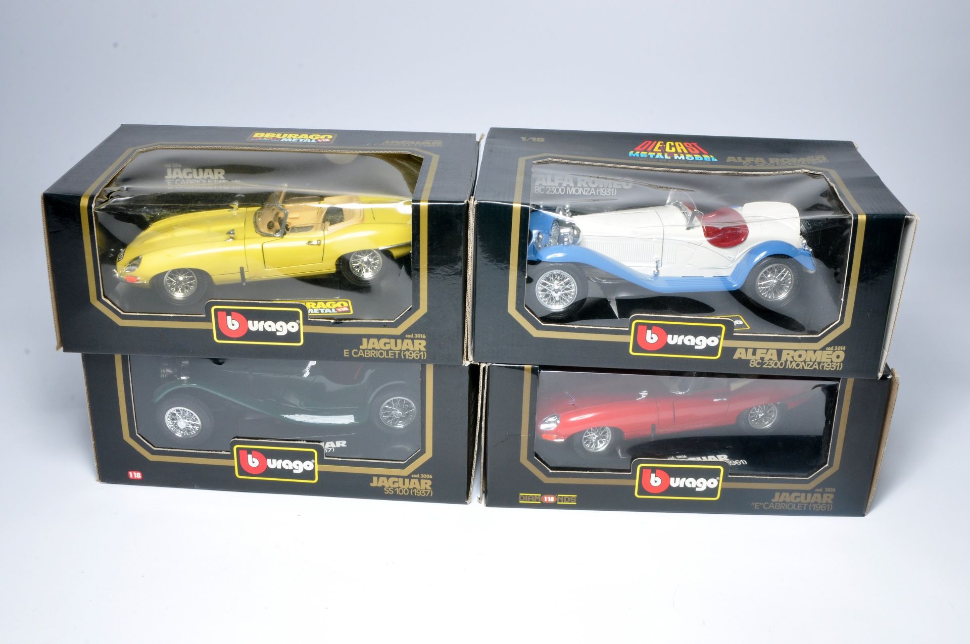 A group of 4 boxed 1:18 scale diecast vehicles from Burago.