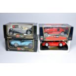 A group of 4 boxed 1:18 scale diecast vehicles from Burago. Displayed.