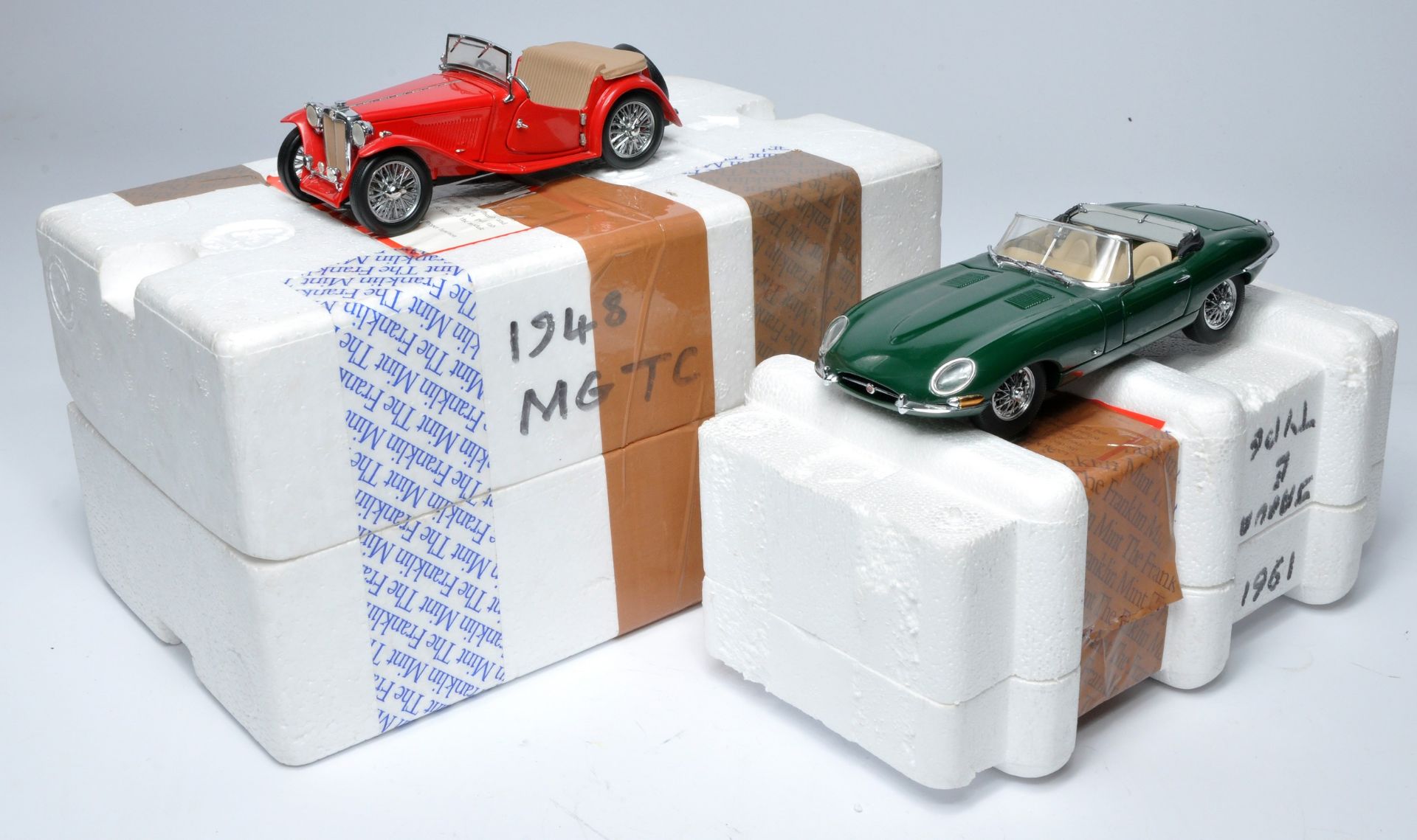 Franklin Mint 1/24 diecast model issues comprising Jaguar E Type plus MGC. Look to be without