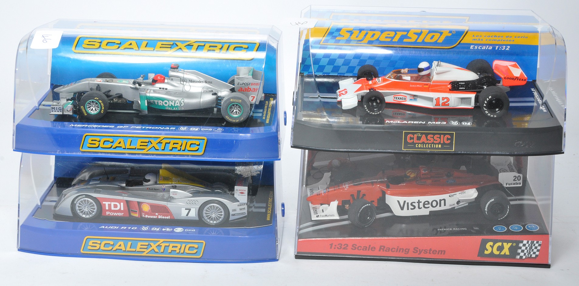 A group of four slot car issues comprising Scalextric Audi R10, Mercedes GP Petronas, SCX Patrick