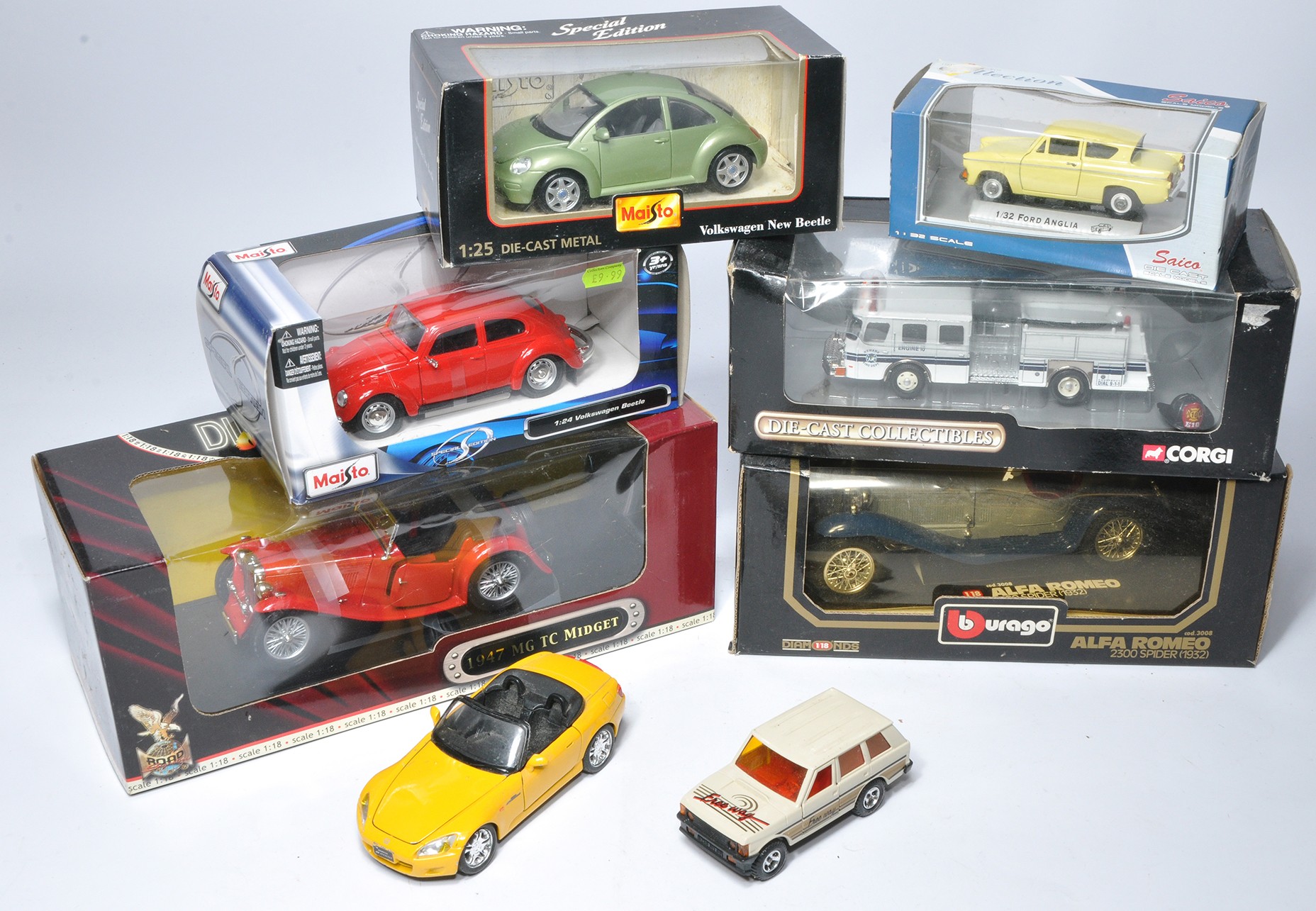 A group of six boxed diecast model vehicles in various scales from Burago, Corgi and others as