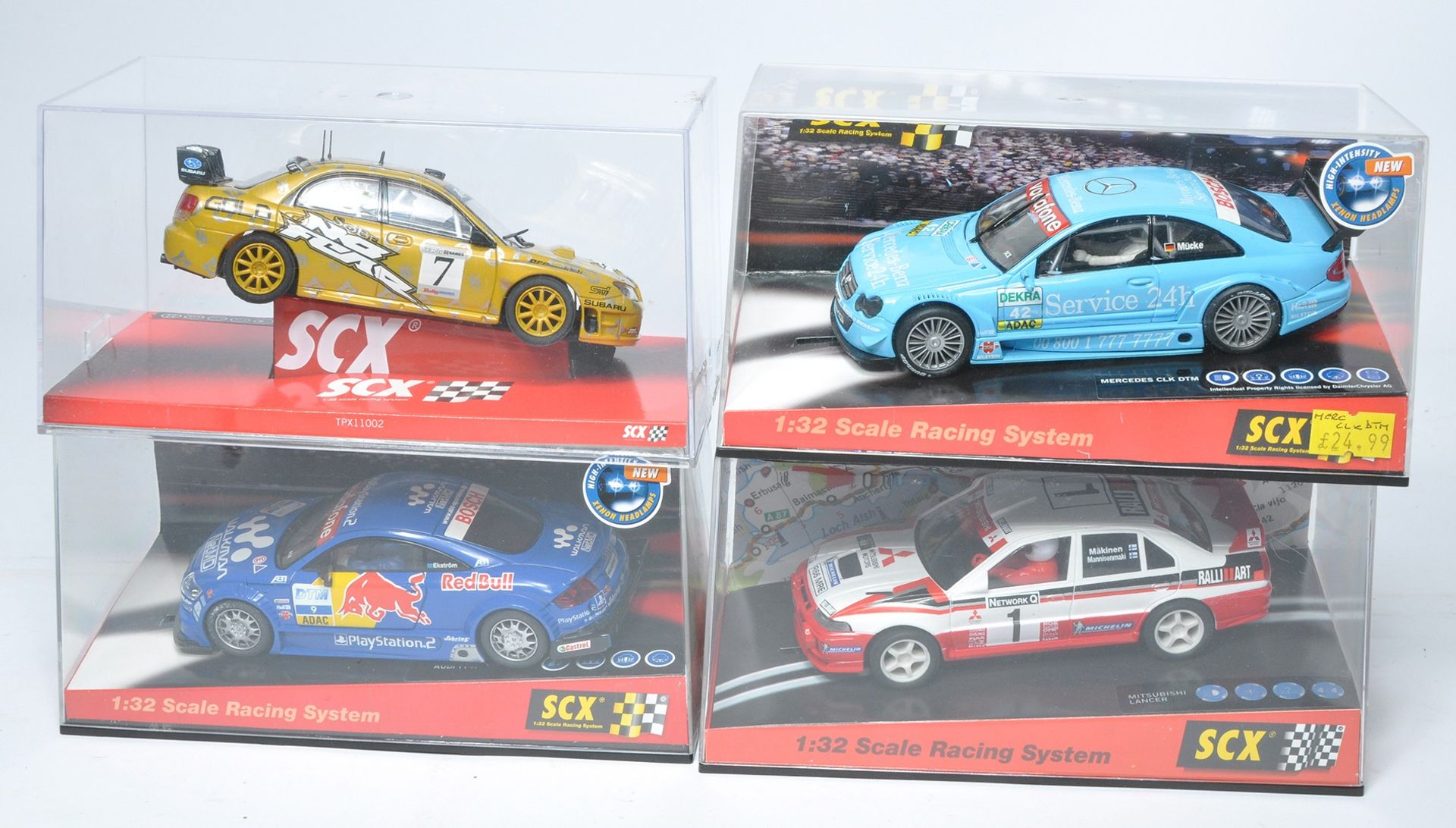 A group of four SCX slot car issues comprising Audi TT-R Red Bull, Subaru Impreza WRC McRae,