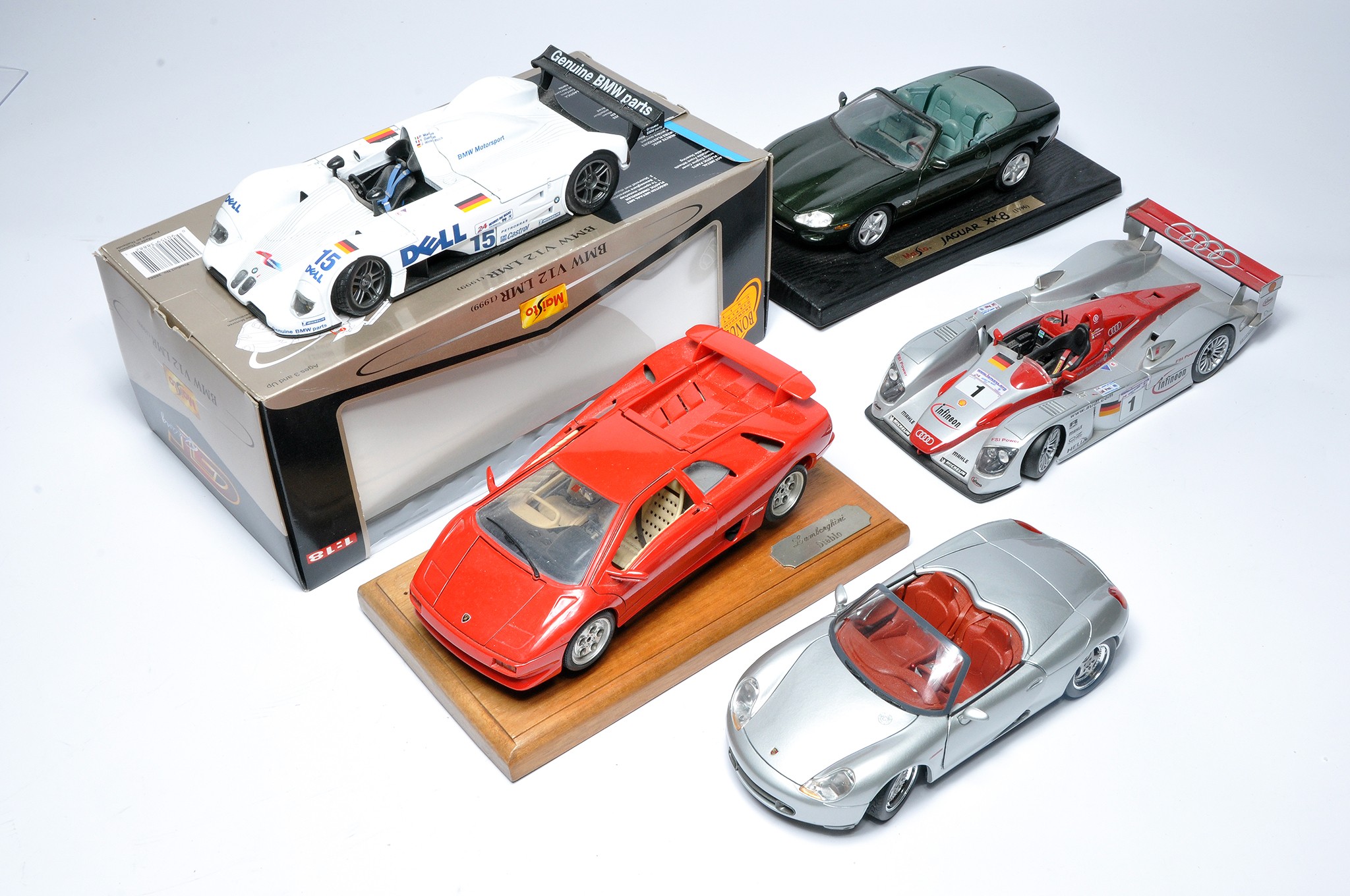 A group of 1/18 diecast model racing cars from Maisto, mostly. One is boxed.