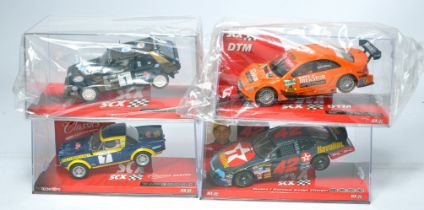 A group of four SCX slot car issues comprising Fiat 124 Spyder, Texaco/Havoline Dodge Charger,