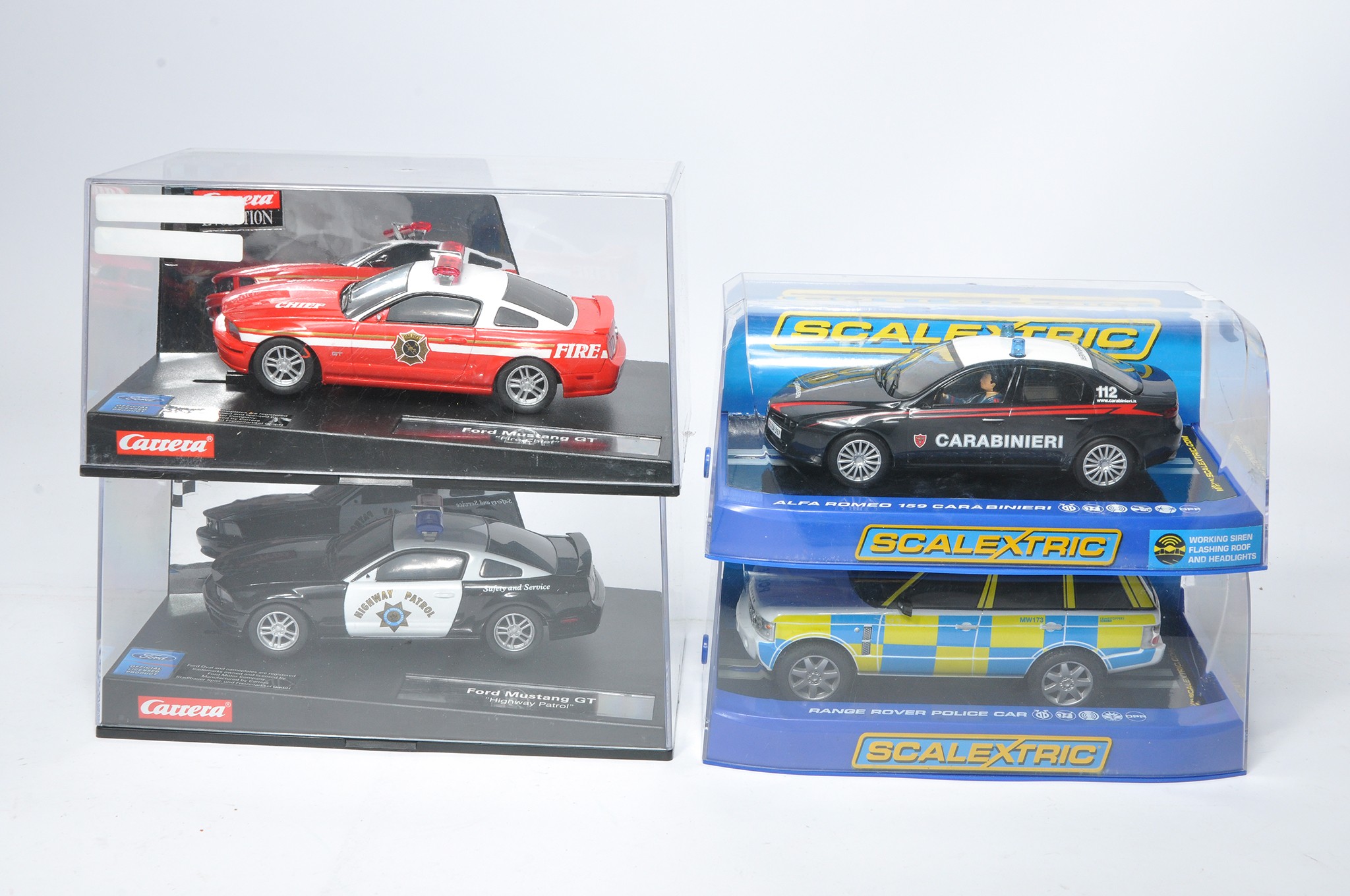 A group of four slot car issues comprising Scalextric Alfa Romeo 159 Carabinieri, Range Rover Police