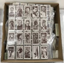 A collection of various cigarette cards, sports,