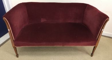 An Edwardian mahogany and satinwood strung framed upholstered two seat salon sofa on square tapered