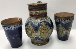 A Doulton Royal commemorative ale jug for Victoria's Golden Jubilee 1897 together with two beakers