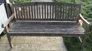 A slatted teak garden bench seat,