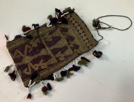 A Native American purse with purple ground and silver wire and white beaded tassel decoration 19 cm