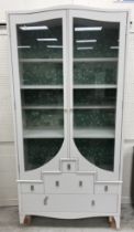 A Philip Warren painted display cabinet with two glazed doors enclosing adjustable shelving above a