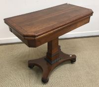 An early 19th Century mahogany and cross banded fold over card table on square tapered pedestal