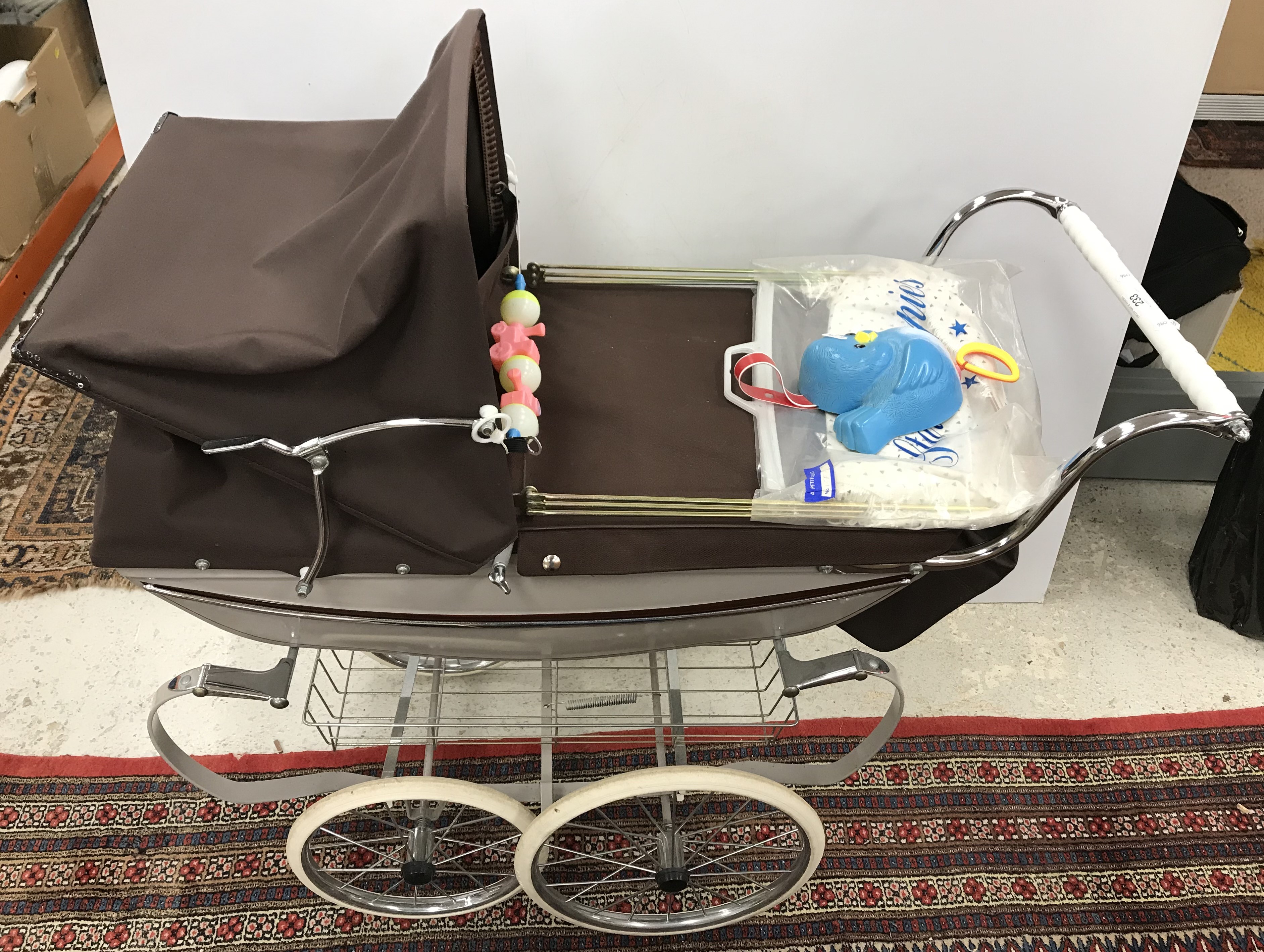 A Silver Cross coach built doll's pram in grey and burgundy with shopping tray, bag,