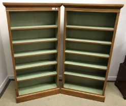 A pair of walnut open bookcases in the Georgian style,