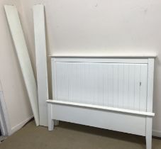 A modern white painted double bedstead on square supports,