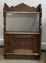 A Victorian mahogany dwarf cupboard with two arched panelled doors enclosing shelving,