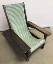 A circa 1900 Arts & Crafts oak plantation type chair attributed to Liberty of London,