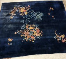 A vintage Chinese carpet, the plain blue ground set with floral sprays approx.