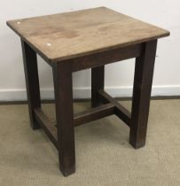 A circa 1900 oak cafe table of square form raised on square supports united by an H stretcher 68 cm